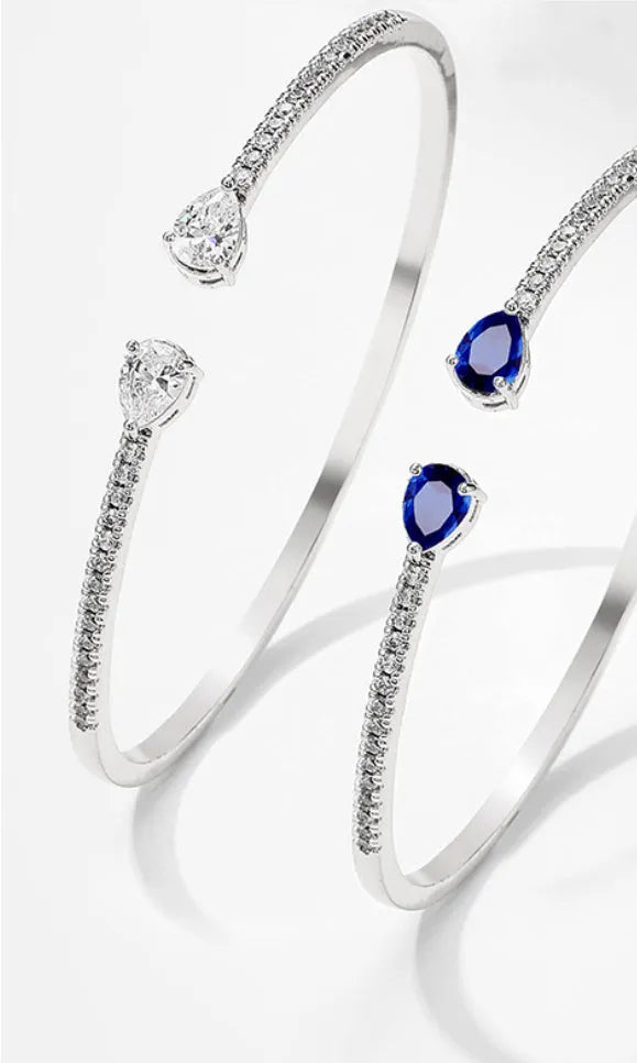 Personalised copper bracelet with multi-zircon inlay, shown in white and blue colour options