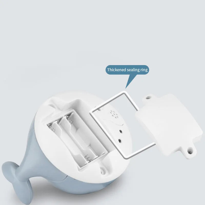 Automatic water spray whale bath toy with lights on a blue base.