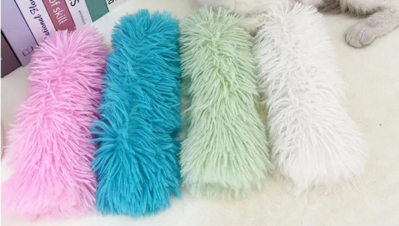 Plush cat toy pillow in blue, green, pink, and white colours, shown at 27cm by 10cm size