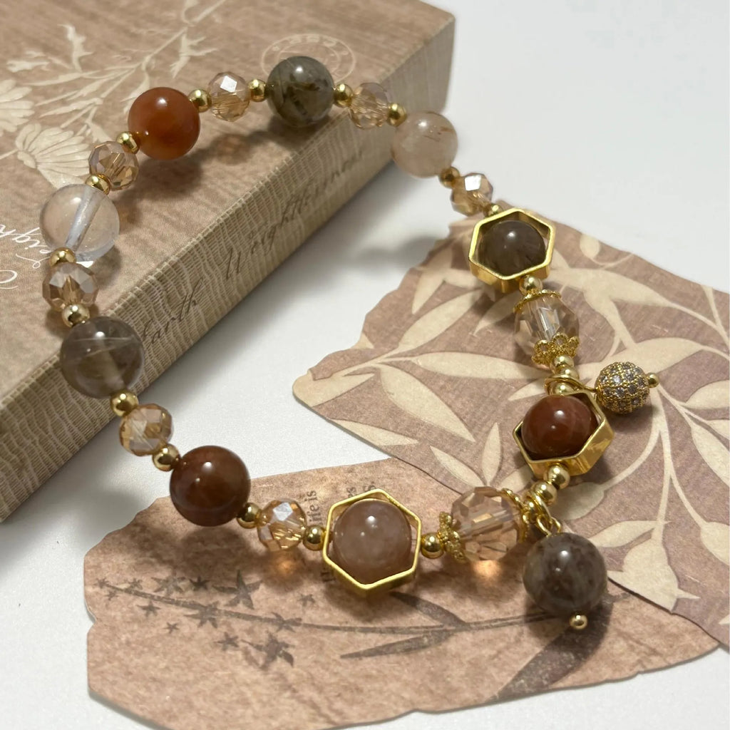 Gold-coloured citrine bracelet with hand-woven construction showing auspicious Chinese symbols