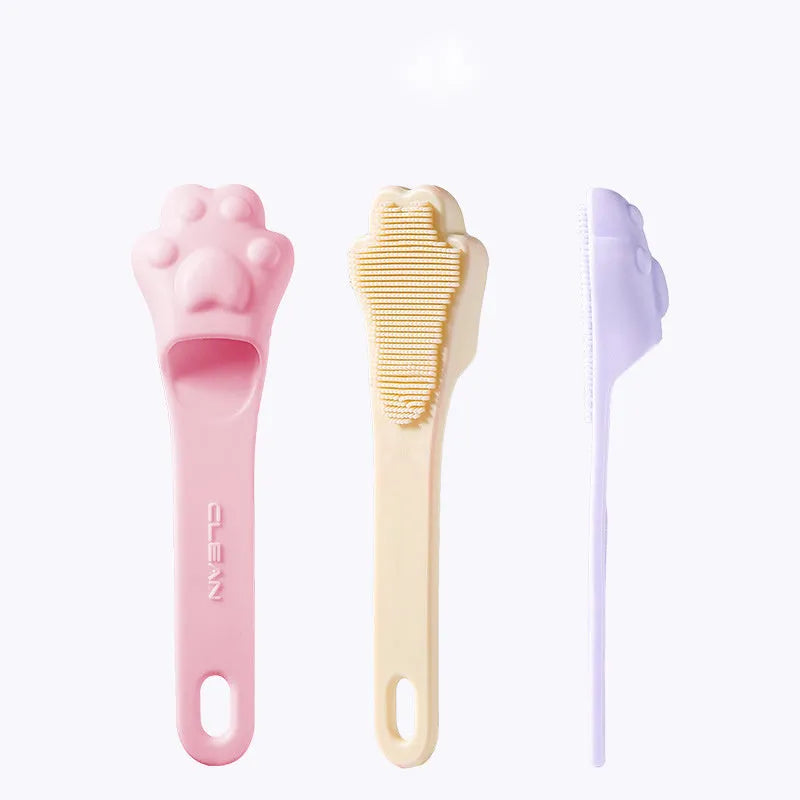 Silicone fingertip toothbrush for pets in pink, purple, and yellow, shown on a finger.