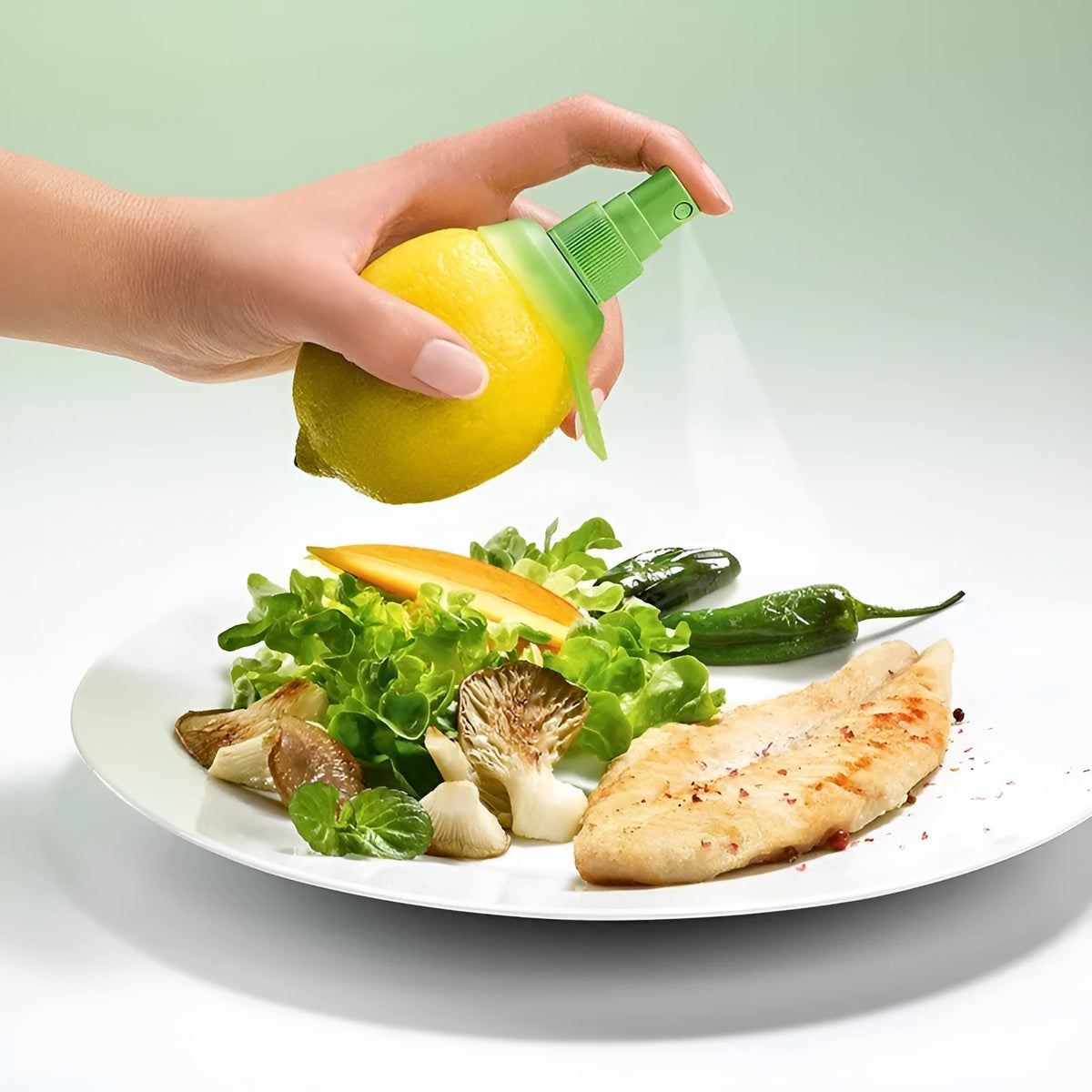 Green lemon sprayer with screw-in juicer design and PVC silicone ring at the nozzle for direct fruit juice extraction