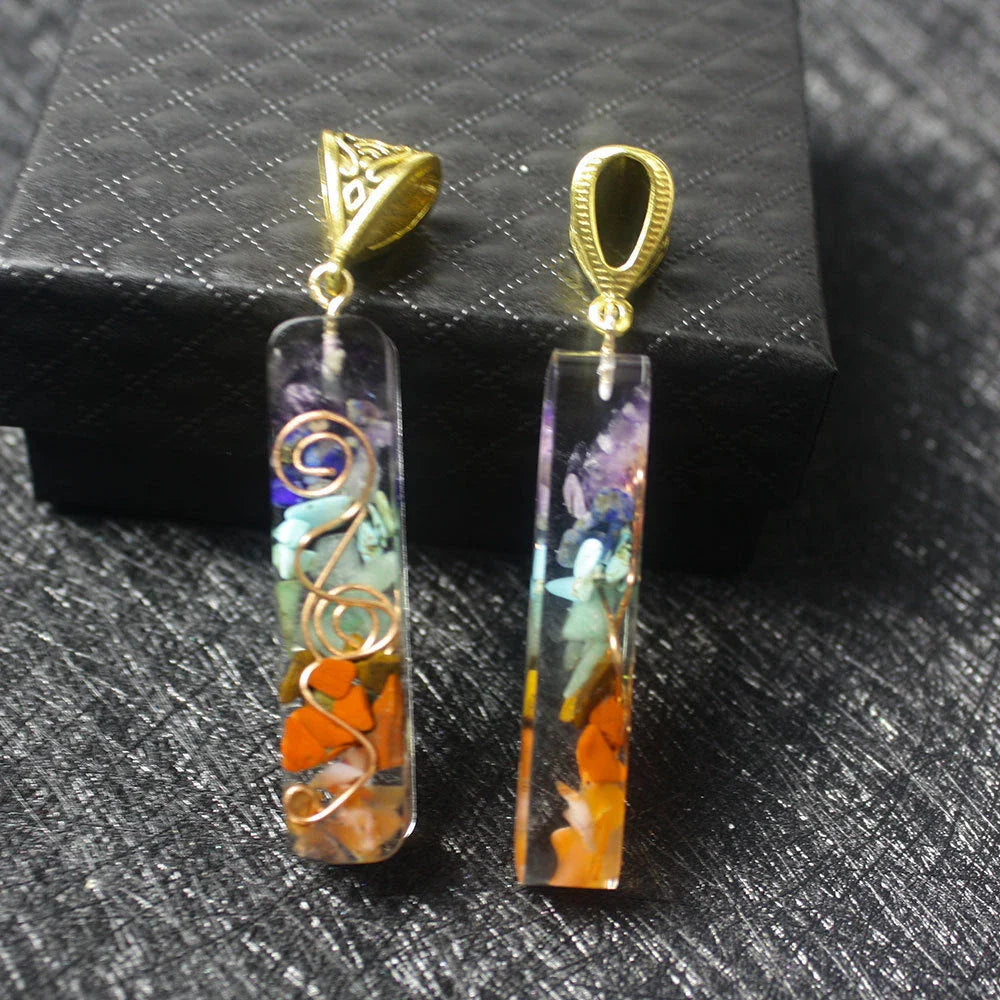 Chakra-inspired acrylic pendant with a unique geometric design and natural variations in the stone patterns