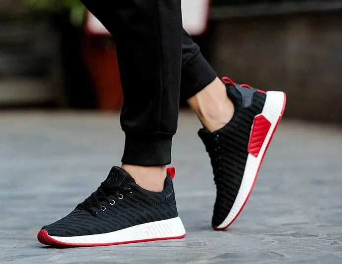 Men Malcolm Sneaker in black from side view showing mesh fabric upper and low-top design