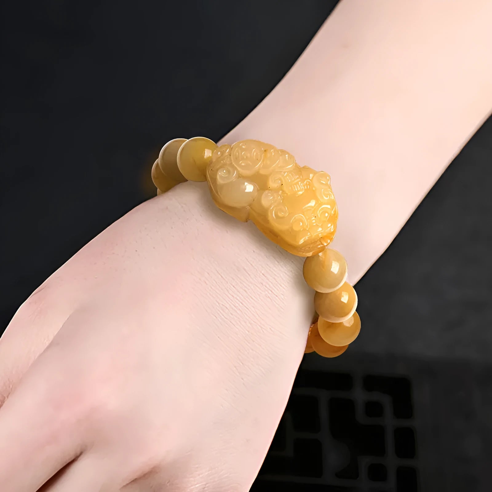 Golden Thread Jinsi Jade bracelet with a carved fortune coin and round jade beads in two size options.
