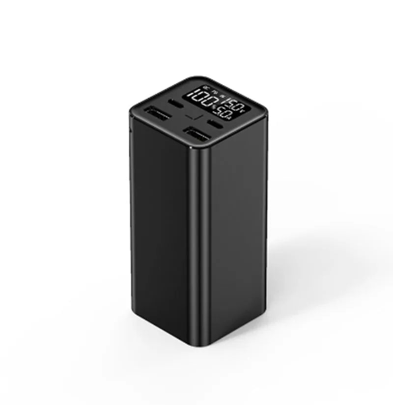 65W metal laptop power bank in black, blue, or grey colours showing size next to a laptop.