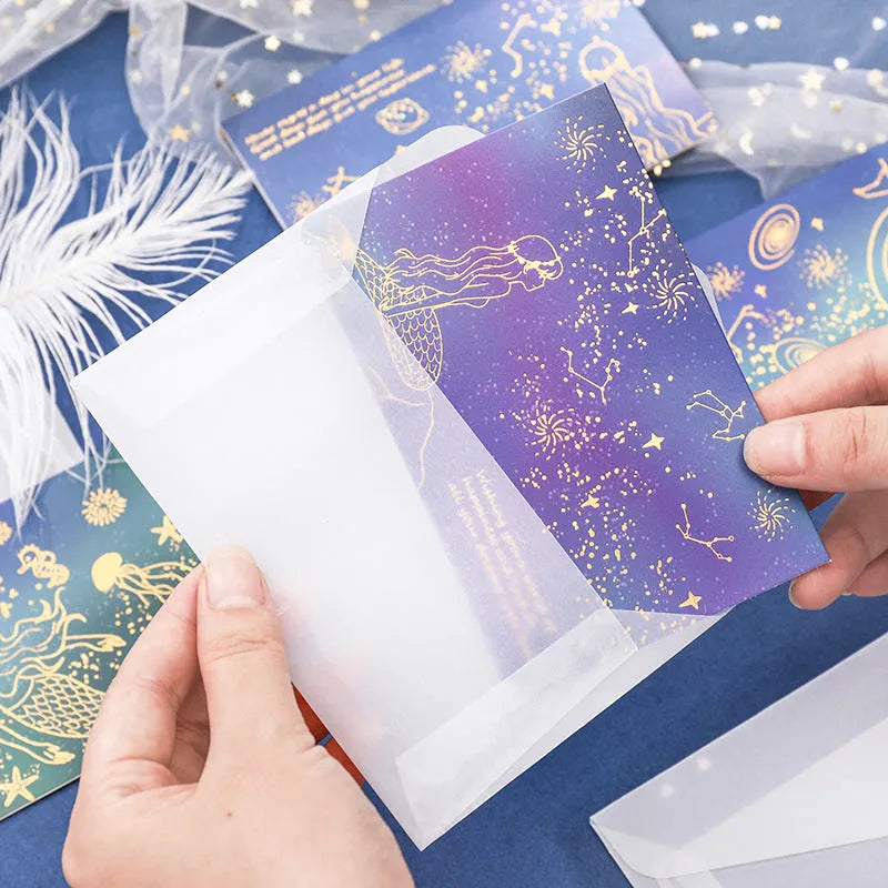 Set of three foldable sulfuric acid paper greeting card envelopes with bronzing, in celestial colours.