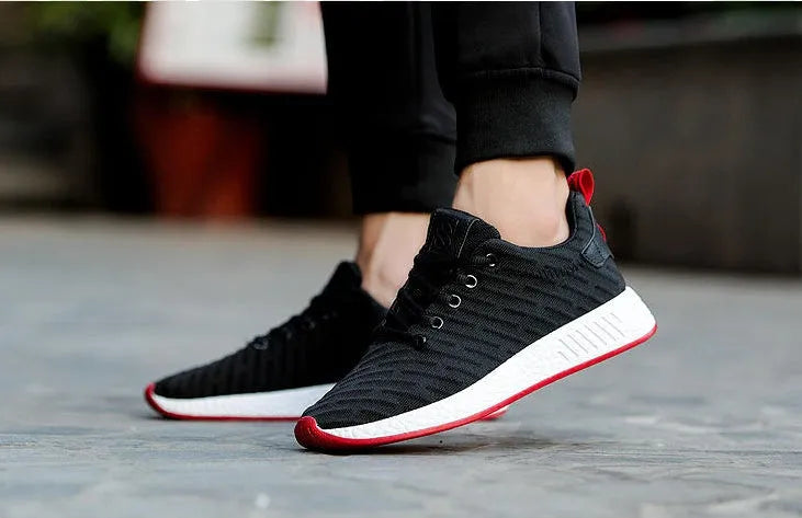 Men Malcolm Sneaker in black from side view showing mesh fabric upper and low-top design