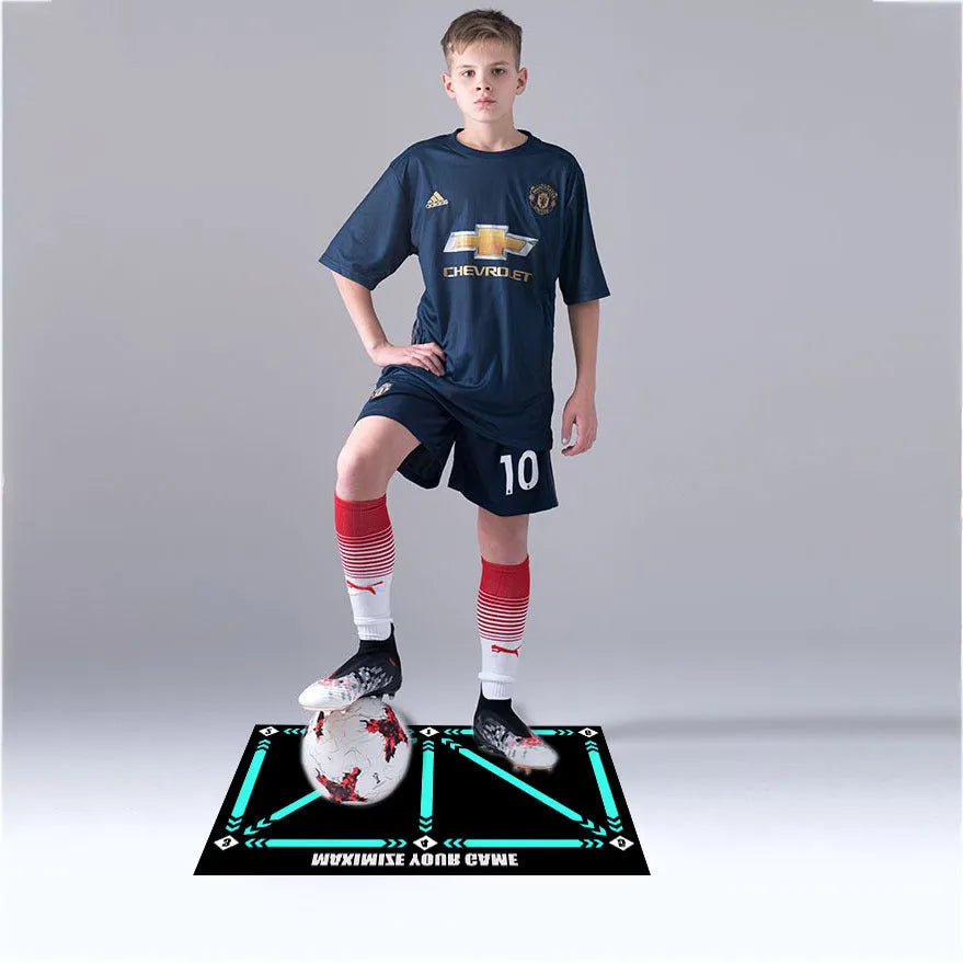 Black rectangular football training mat on grass for non-slip skills practice