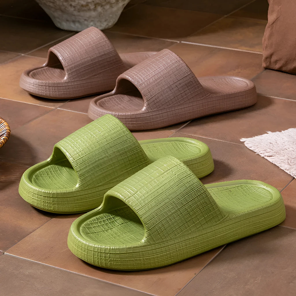 A pair of khaki coloured EVA toe ring slippers with a soft non-slip sole, shown on a white background.