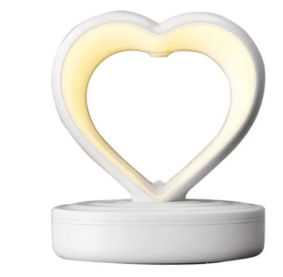 Love Anti Gravity humidifier, heart shaped with water droplet backflow, white colour, with ambience light, on a wooden desk