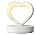 Love Anti Gravity humidifier, heart shaped with water droplet backflow, white colour, with ambience light, on a wooden desk