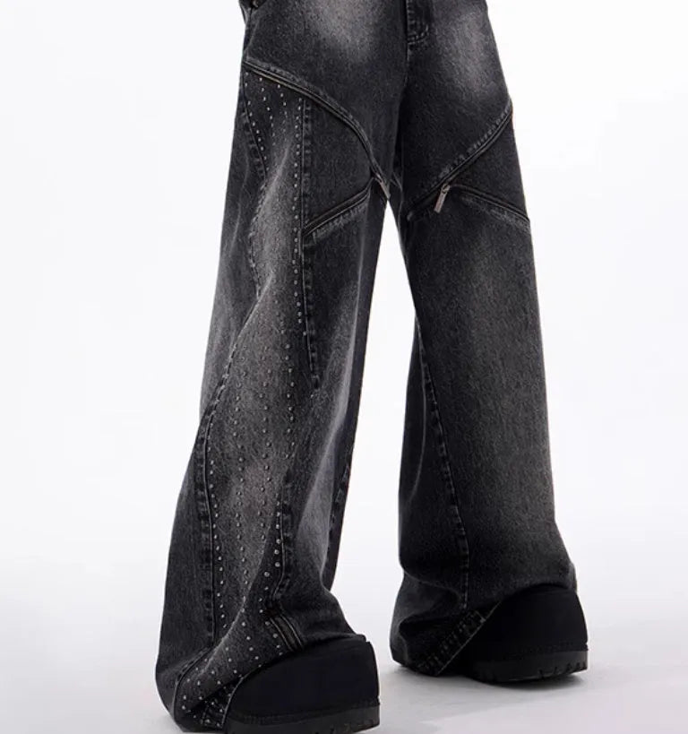 Black and grey washed denim wide leg trousers with structural zipper detail and matching vest, laid flat.
