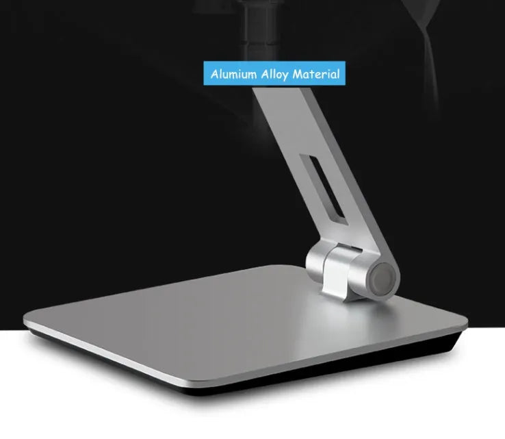 Silver foldable aluminium and ABS phone and tablet stand on a desk, showing 360-degree rotation.