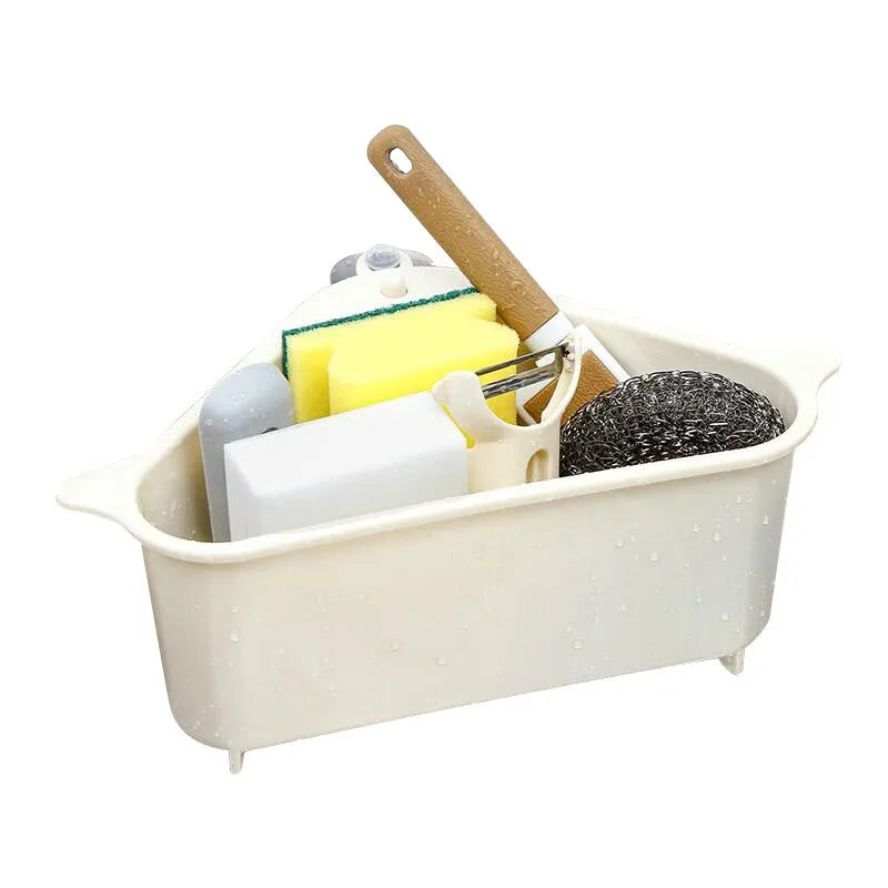 Triangular beige plastic kitchen sink storage rack with suction cup mount holding a sponge.