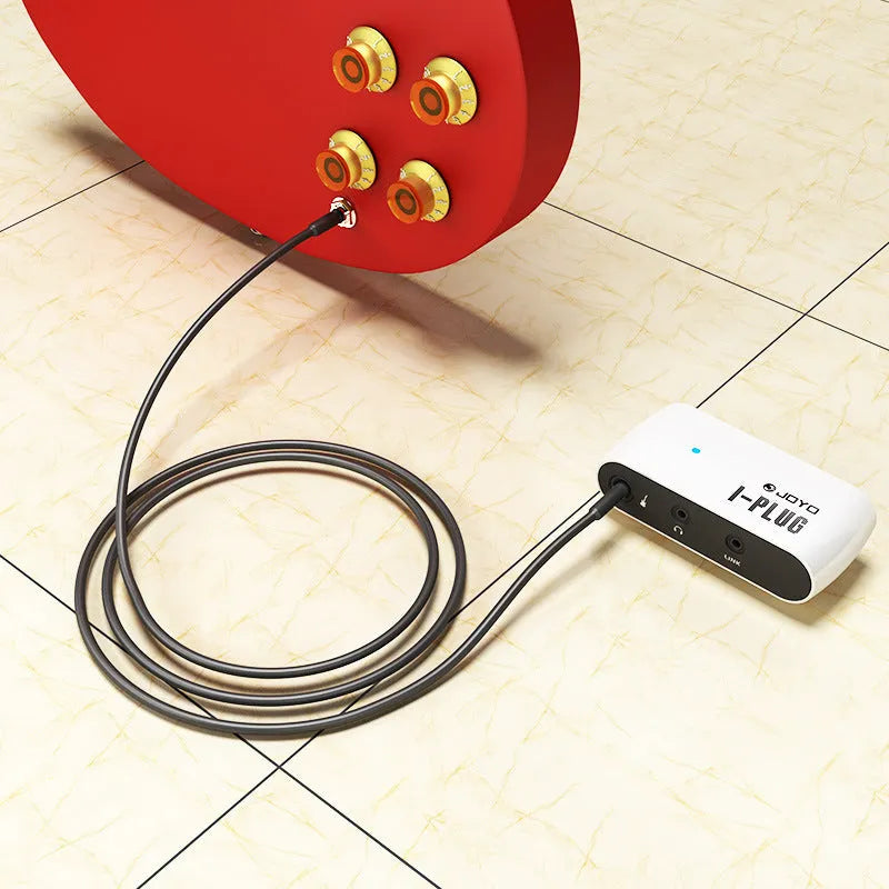White metal distortion headphone amplifier pedal for electric guitar with Link C input connection.