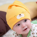 Baby soft cotton sleeping cap with cartoon bear pattern in blue, on a white background