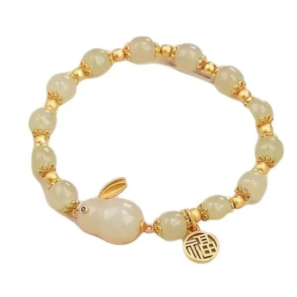 Green electroplated bracelet with a Chinese style hare charm and lily decoration for women.