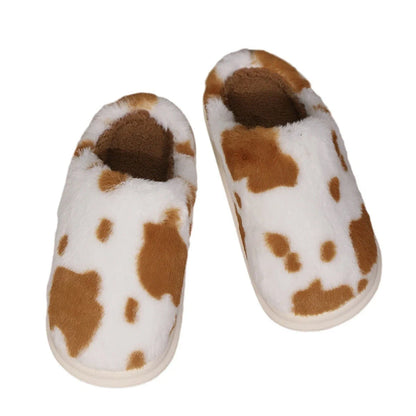 Cozy cow-print plush slippers with soft, fluffy material and non-slip soles for warm, comfortable indoor wear