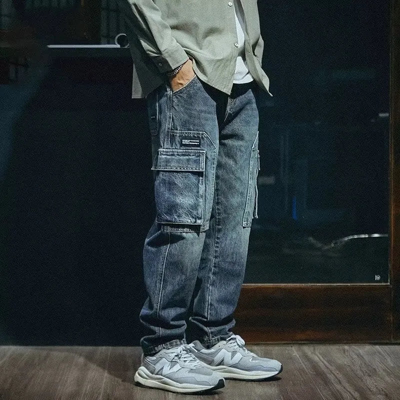 Man wearing blue loose straight-leg retro jeans with a zip fly, showcasing the casual fit.