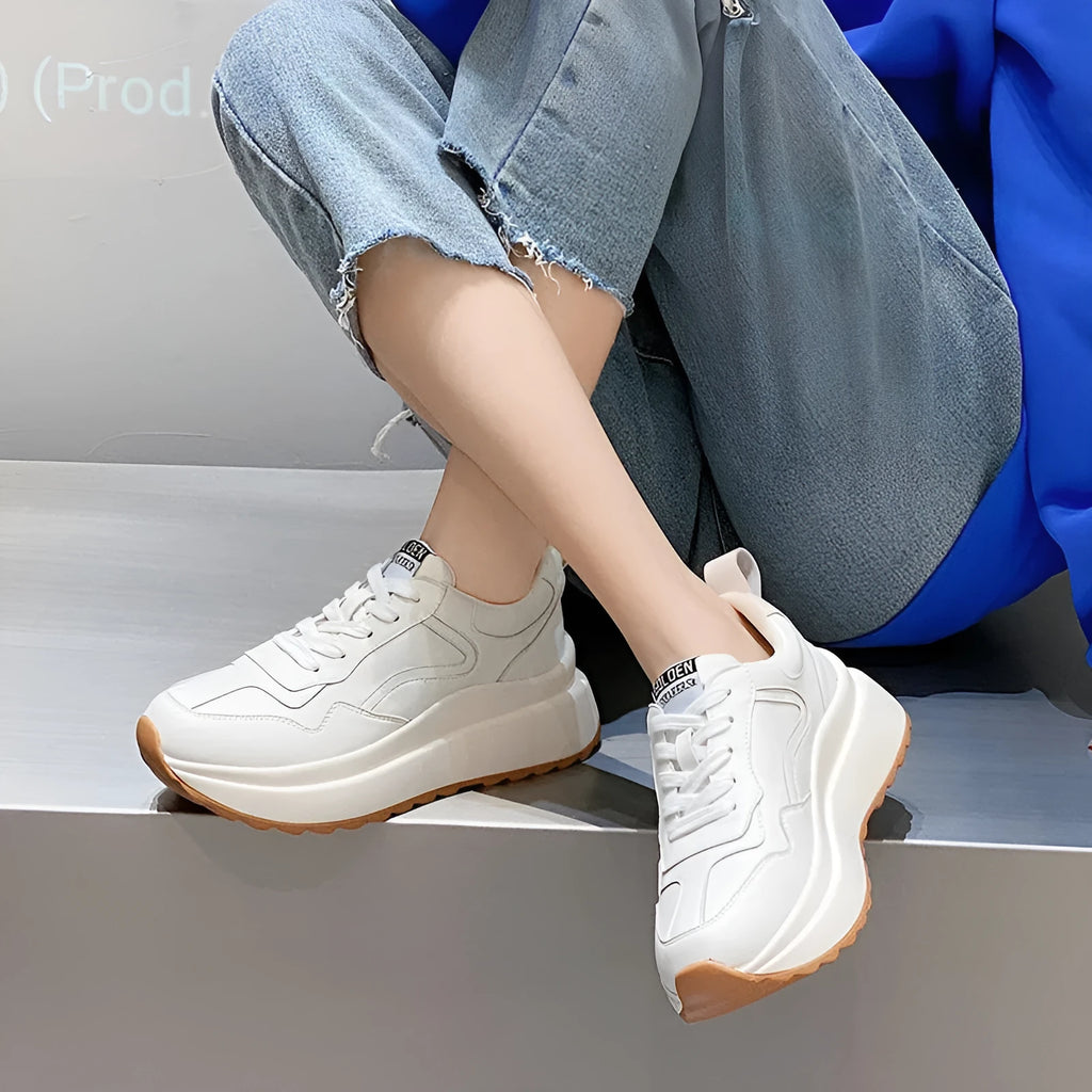 Women's beige cattlehide leather low-top casual sports shoes with cross strap and round toe.