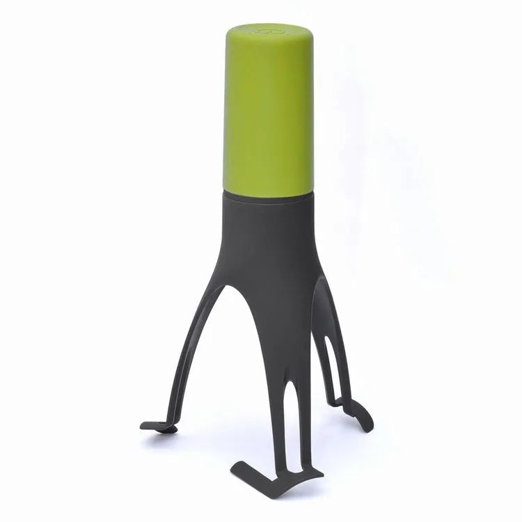 Green Uutensil Stirr automatic handheld mixer for pots, showing its compact size.
