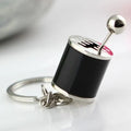 Metal gear shift keychain in polished silver with movable 6-speed and reverse lever