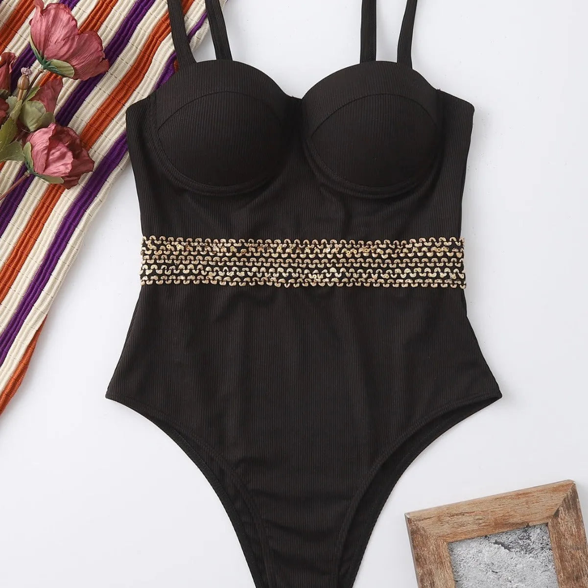 Black one-piece women's swimsuit bikini with adjustable shoulder straps on a white background.