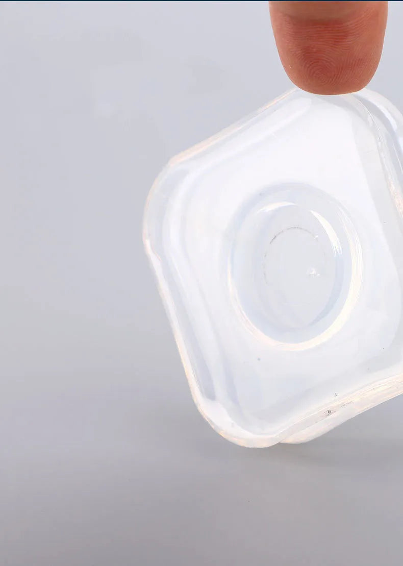 Transparent reusable nano gel adhesive pads in circular and square shapes on a smooth surface