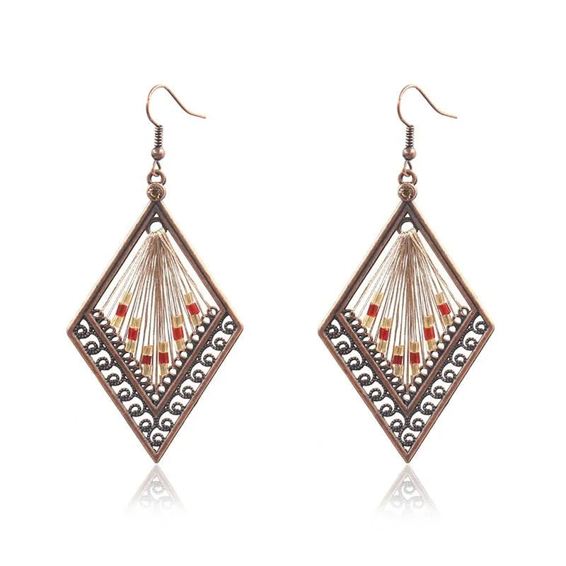 Bohemian hand-woven gold thread alloy earrings with geometric quadrilateral shape on a white background