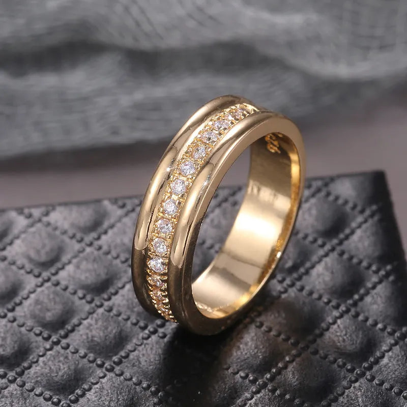 Gold-plated copper geometric ring with inlaid zircon on white background