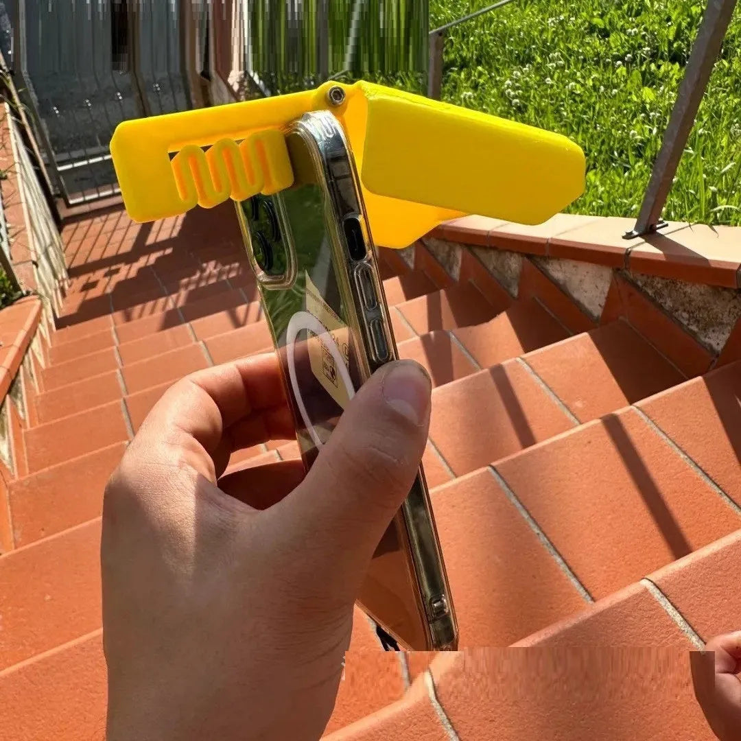 Yellow foldable plastic phone sunshade holder with phone clip for beach use.