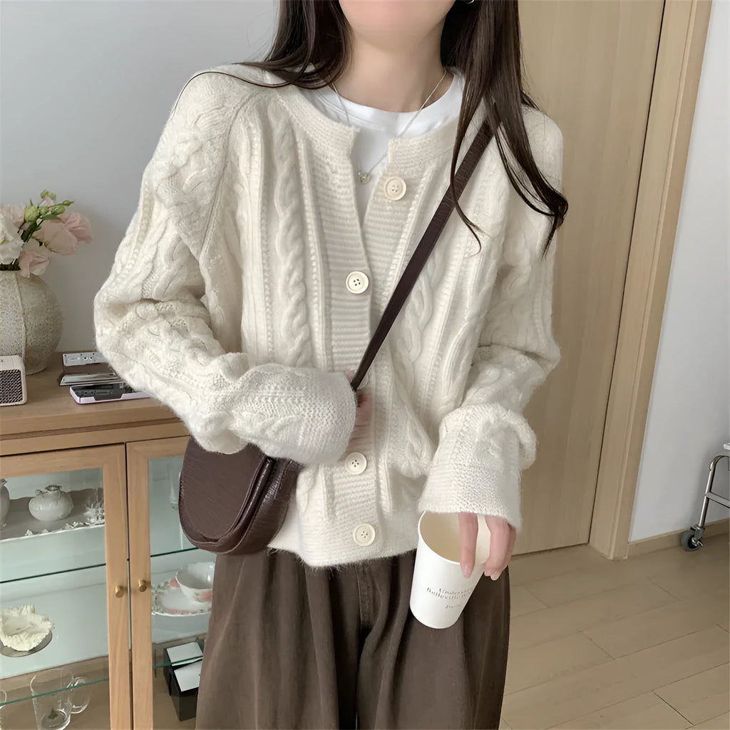 Women's loose-fit twist knit cardigan in solid colour with button front on a model