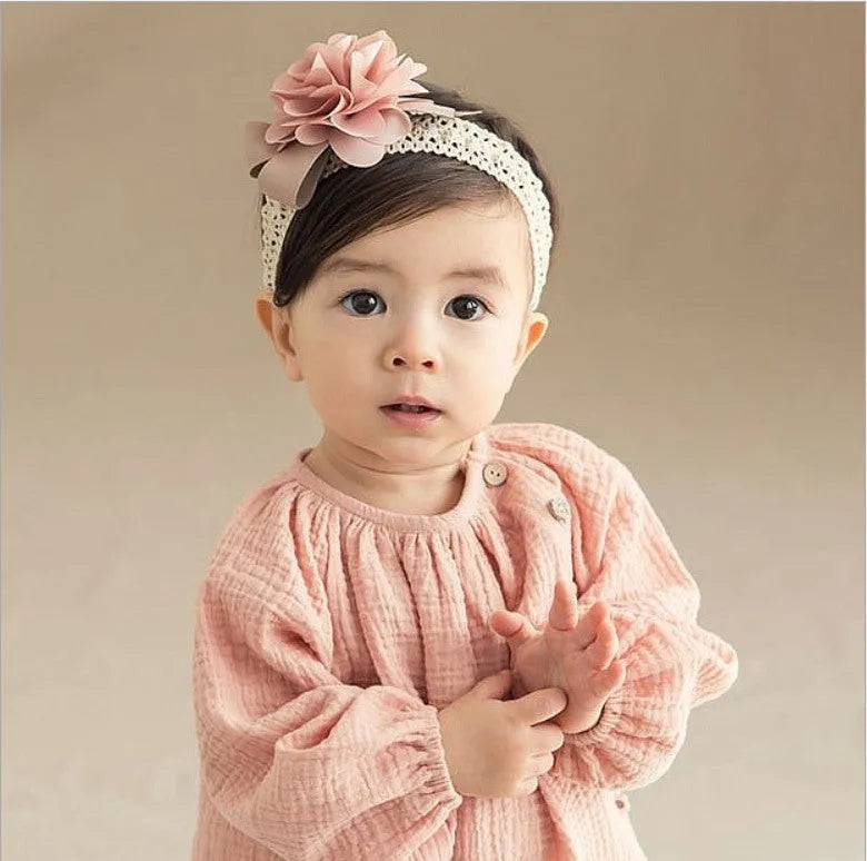 Baby lace headband with fabric flower in grey on a white background