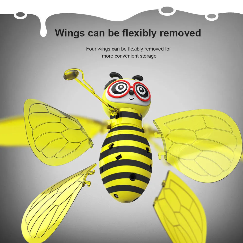 Yellow mini flying ball bee drone with infrared gesture sensing, ABS plastic body, and removable wings on a white background