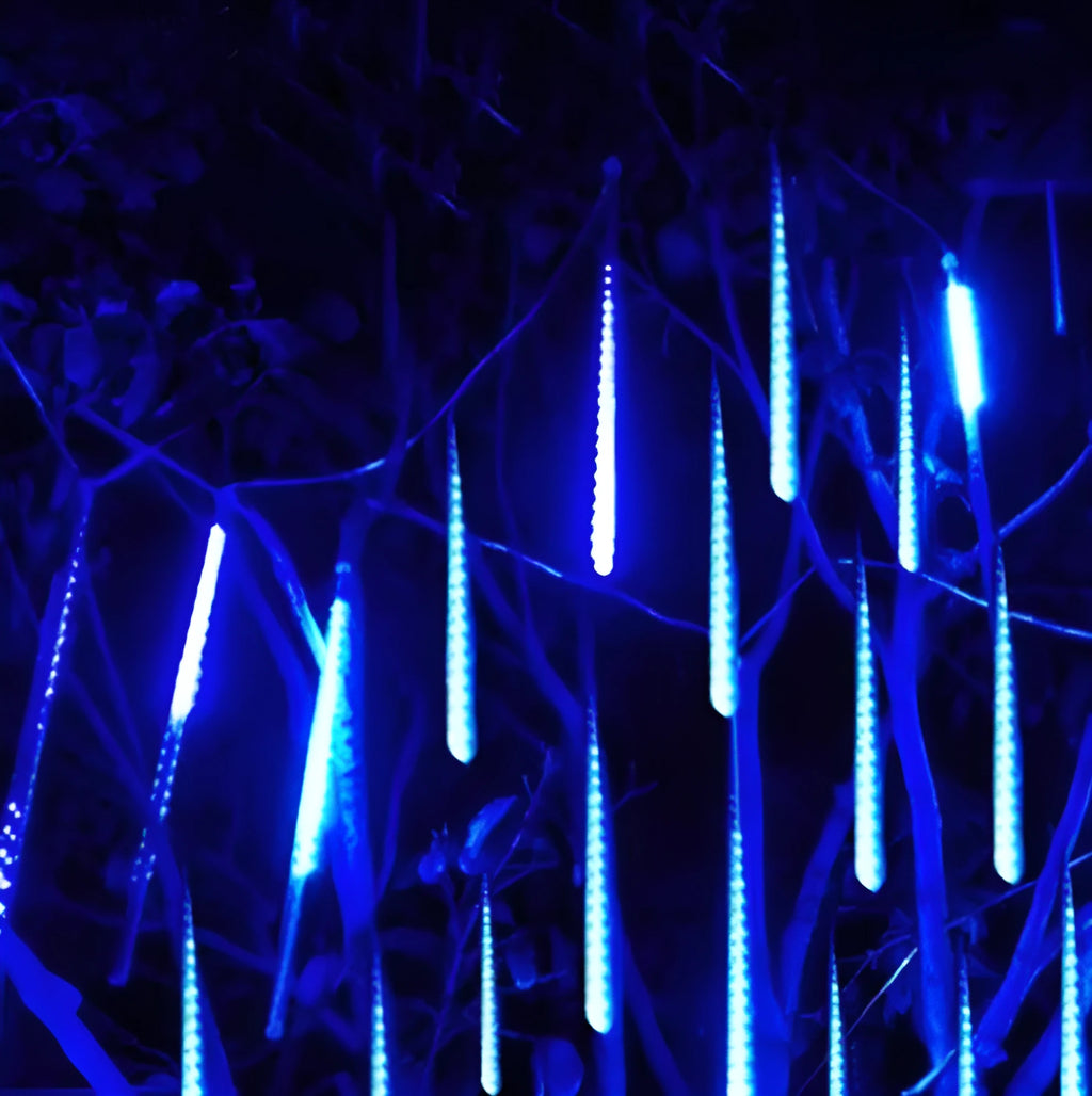 Waterproof blue LED meteor shower tube light creating a raining light effect outdoors.