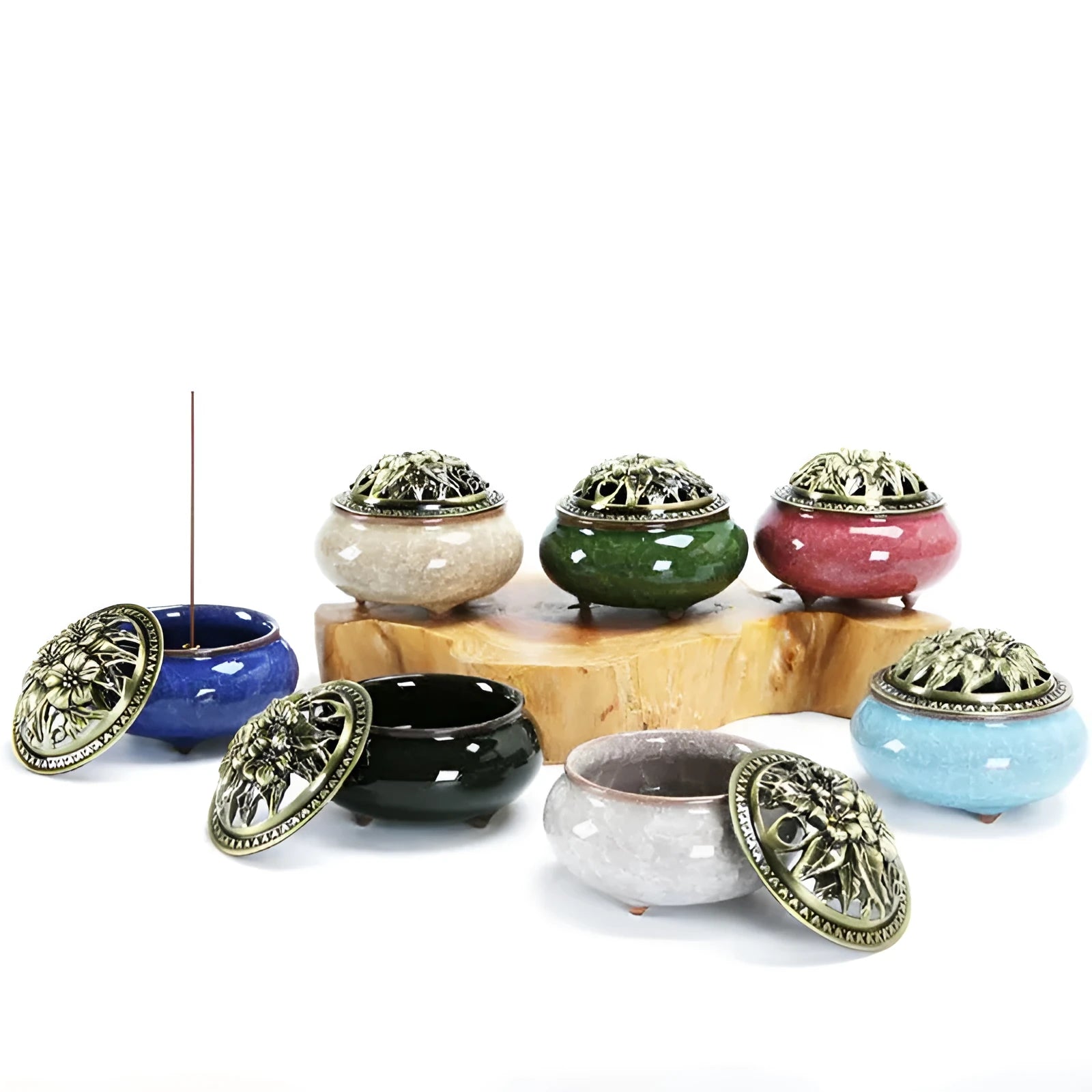 Ceramic incense burner with retro packaging in various colours on wooden surface.