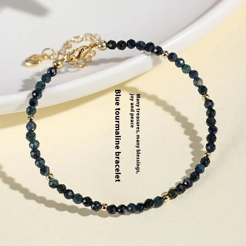 Blue tourmaline beaded bracelet with spacer beads on wrist showing 3mm gemstone size