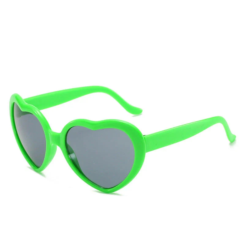 Heart-shaped glow-in-the-dark sunglasses in various vibrant colors, featuring a durable plastic frame and resin lenses for reliable UV protection.