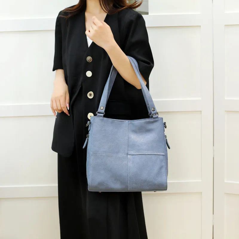 Soft PU retro style crossbody handbag in barrel shape showing pocket sandwich design.