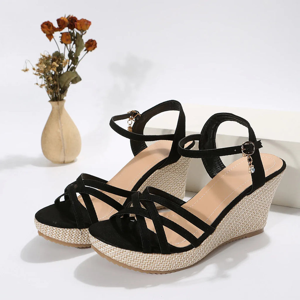 Women's beige and black cloth wedge sandals with a fish mouth open toe design.