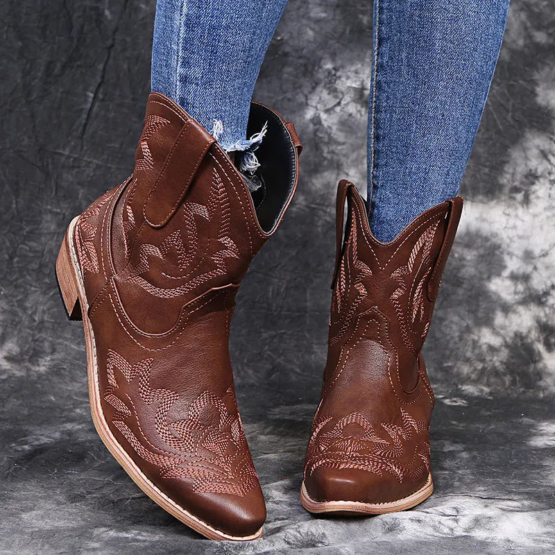 Blue embroidered women's cowgirl boots with a low wedge heel and pointed toe.