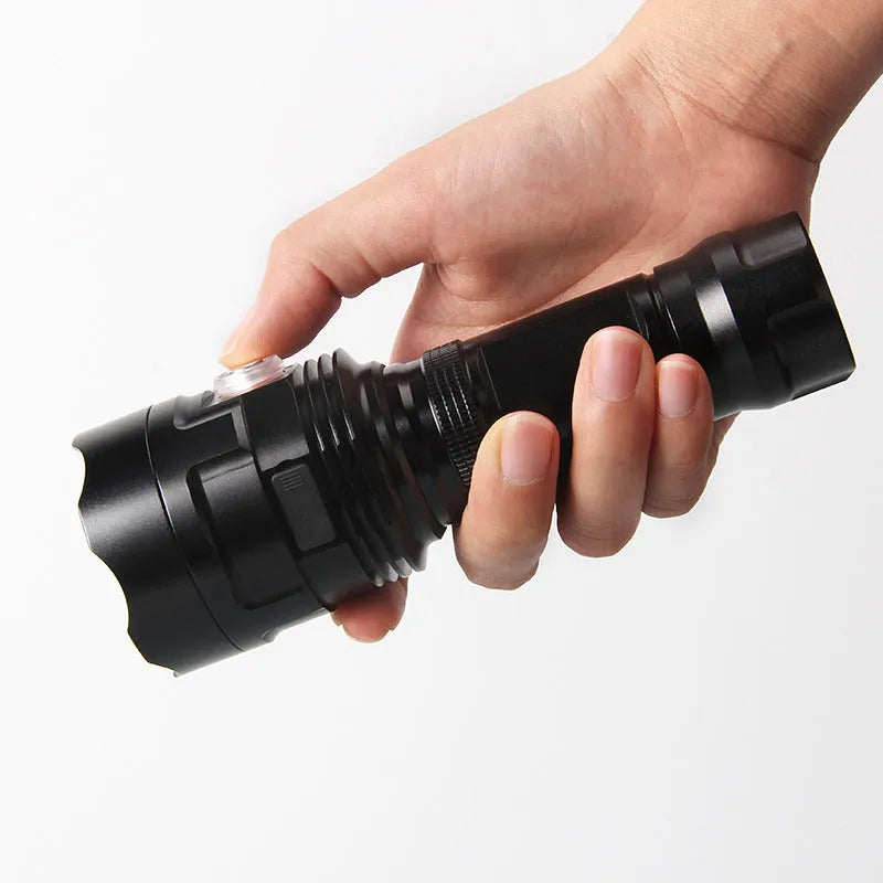 Black anodised aluminium LED flashlight with large head, showing tactical design and side switch