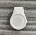 Silicone golf hat clip ball marker holder in bright colours, clipped to a hat and holding a metal ball marker