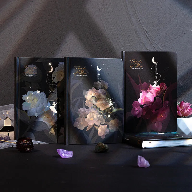 A5 notebook with a luminous cover open to show pages with colour illustrations.