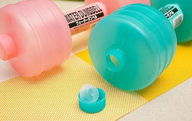 Pair of water-filled fitness dumbbells in pink and green, polypropylene, approximately 1kg each when filled