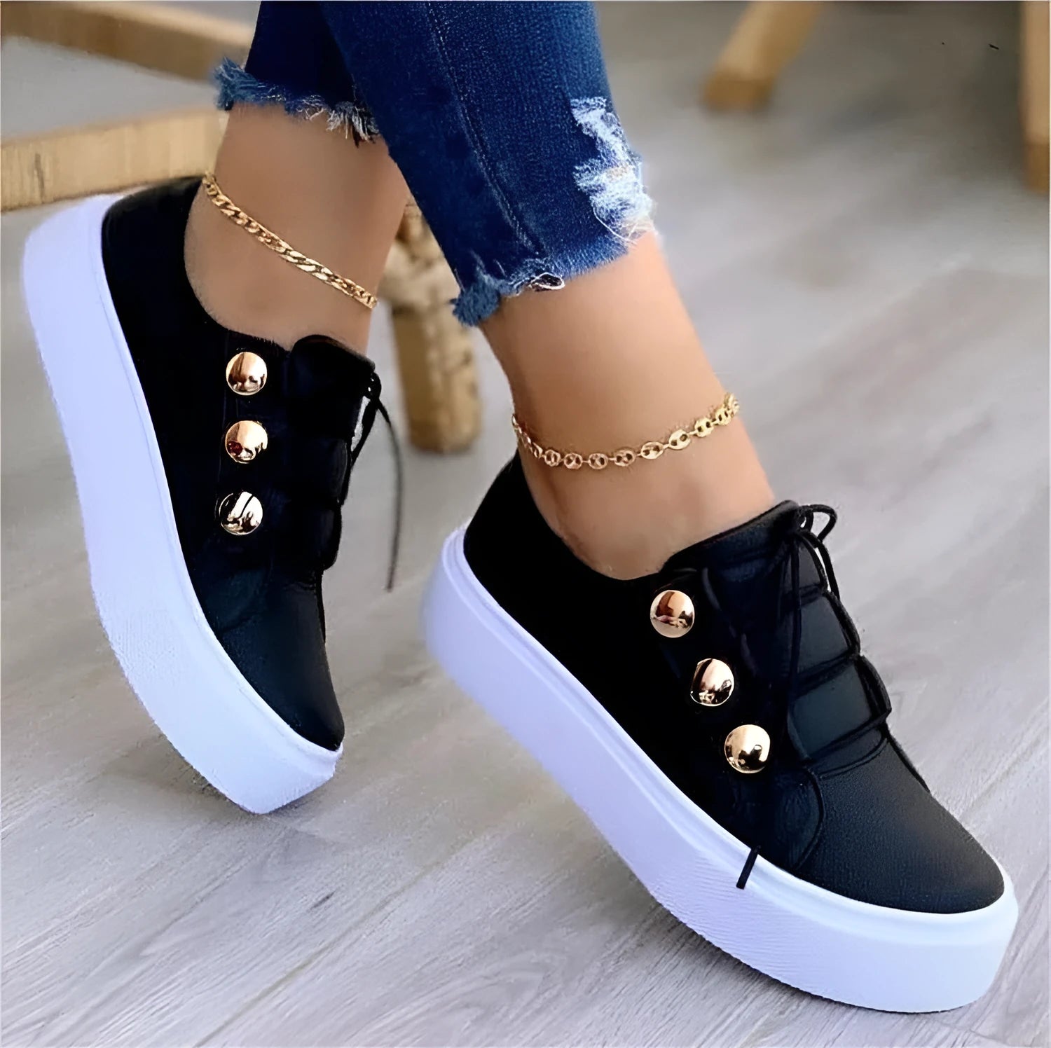 Women's white lace-up flats sneakers with round toe and metallic rivet detailing on a low upper.