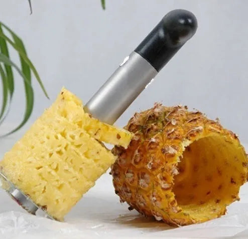 Stainless steel pineapple corer slicer with coloured ABS handle on kitchen counter