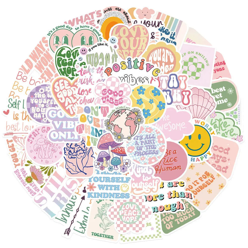 Danish pink motivational statement stickers with graffiti and cartoon designs on a laptop.