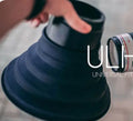 Black conical silicone camera lens hood for reducing glare when shooting through windows, shown in large and small sizes.